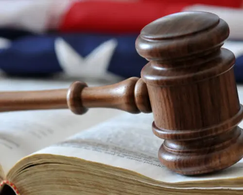 gavel on book in front of American flag