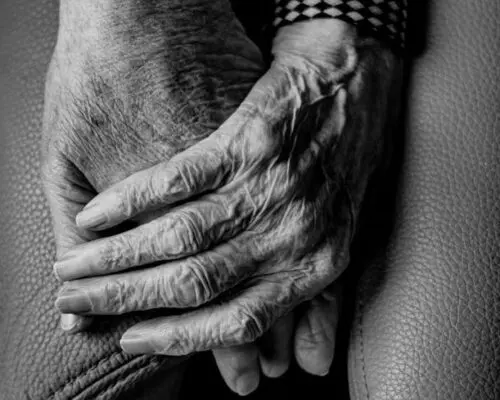 closeup of hands of two elderly people holding hands