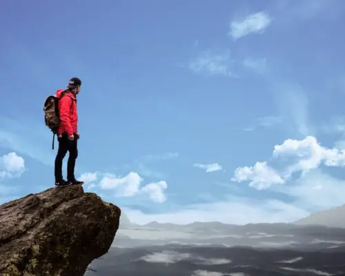 hiker at cliffs edge