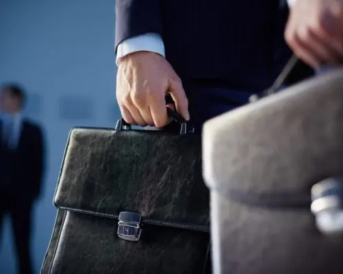 Lawyers holding brief cases.