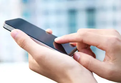 cellphone in hand, finger selecting item