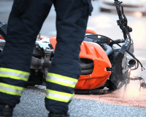 Firefighters cleaning up after motorcycle accident.