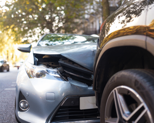 Front end of a damaged car after a collision with another vehicle on a residential street, illustrating a Colorado Springs car accident and the concept of diminished value claims for reduced resale value after repairs.
