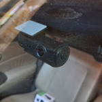 Dash camera mounted on a car windshield recording the road ahead, illustrating how video footage can capture evidence in a vehicle accident.