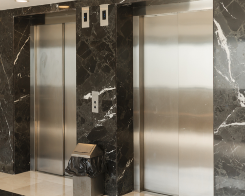 Modern elevator doors in a commercial building lobby, representing elevator accident investigations, premises liability, and injury claims in Colorado Springs.