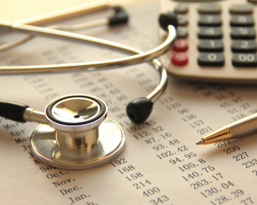 A stethoscope resting on medical billing documents alongside a calculator and pen, representing the importance of tracking healthcare expenses and financial documentation after a serious accident.