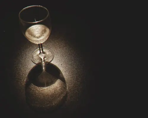 White wine glass under spotlight