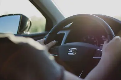 man holding steering wheel