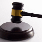 Close-up of a judge’s gavel with a gold band resting on its base, symbolizing how bail is determined in Colorado Springs courts based on statutory factors, risk assessments, and new restrictions under Amendment I for serious offenses like first-degree murder.