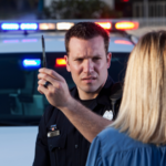 Police officer administering a roadside sobriety test during a traffic stop, illustrating potential reliability issues with motorcycle field sobriety tests in Colorado Springs DUI cases.