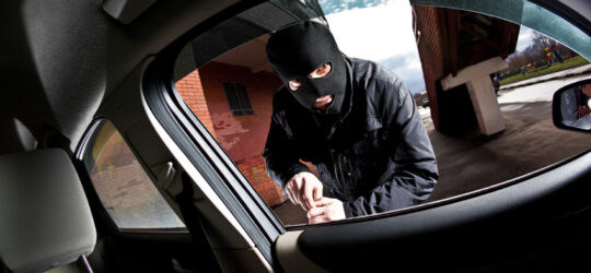 person breaking into car