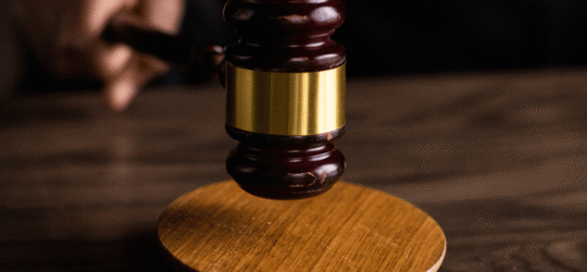 Gavel hitting round block of wood