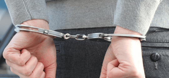 Man with handcuffed wrists behind his back