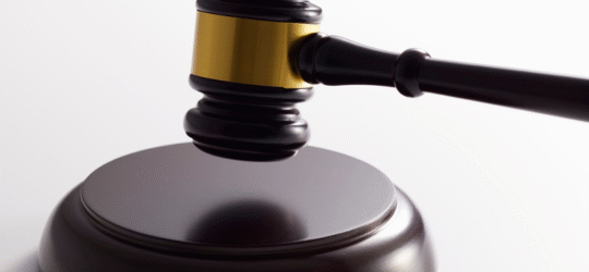 Close-up of a judge’s gavel with a gold band resting on its base, symbolizing how bail is determined in Colorado Springs courts based on statutory factors, risk assessments, and new restrictions under Amendment I for serious offenses like first-degree murder.