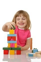 child playing with wooden blocks