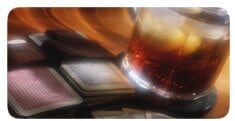 playing cards next to an alcoholic drink