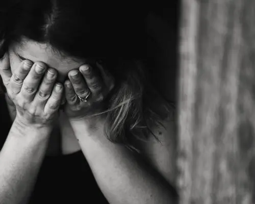 upset woman, head in hands