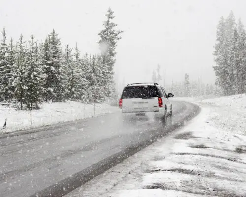 car driving along snowy road
