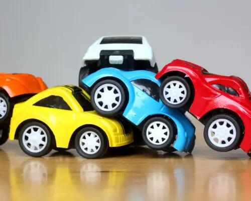 multiple toy cars piled on top of one another