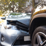 Front end of a damaged car after a collision with another vehicle on a residential street, illustrating a Colorado Springs car accident and the concept of diminished value claims for reduced resale value after repairs.