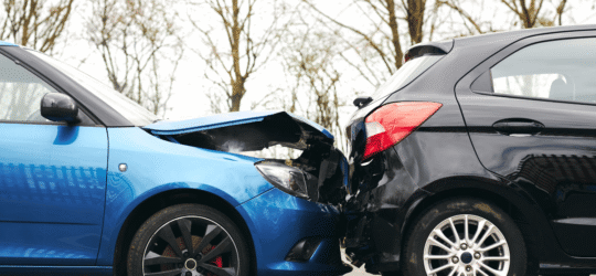 A rear end accident between two sedans.
