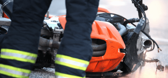Firefighters cleaning up after motorcycle accident.