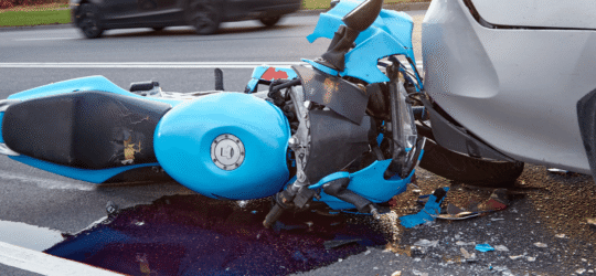 Motorcycle crash with car on city road